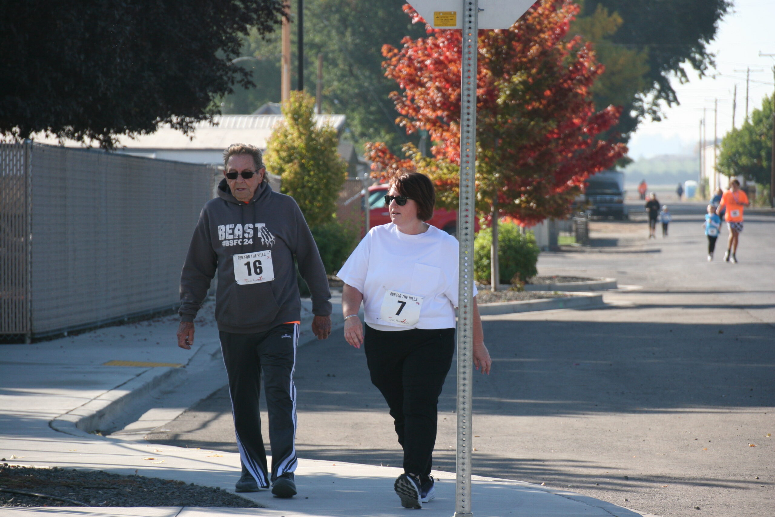 Runners crossing the finish line arch at the 2022 Run for the Hills race in Fruitland, Idaho